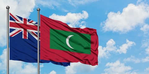 New Zealand and Maldives flag waving in the wind against white cloudy blue sky together. Diplomacy concept, international relations.