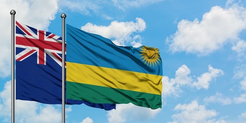 New Zealand and Rwanda flag waving in the wind against white cloudy blue sky together. Diplomacy concept, international relations.