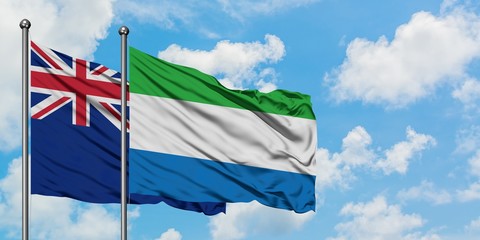 New Zealand and Sierra Leone flag waving in the wind against white cloudy blue sky together. Diplomacy concept, international relations.