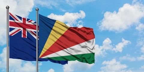 New Zealand and Seychelles flag waving in the wind against white cloudy blue sky together. Diplomacy concept, international relations.