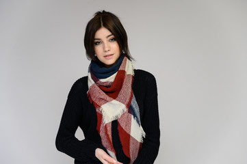 Close-up portrait of a young pretty girl student with long black hair with a scarf and in a...