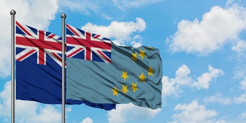 New Zealand and Tuvalu flag waving in the wind against white cloudy blue sky together. Diplomacy concept, international relations.