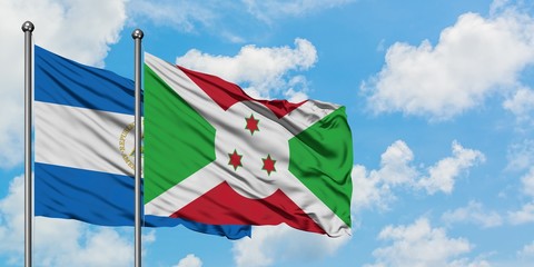 Nicaragua and Burundi flag waving in the wind against white cloudy blue sky together. Diplomacy concept, international relations.