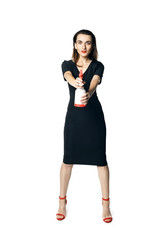 The fatal woman in a black dress with a spray for washing glasses pretending to be a secret agent, holding a spray like a gun. Isolated on a whit