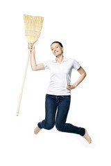Beautiful  woman in a white T-shirt jumping with a broom isolated on a white background, like a housewife 