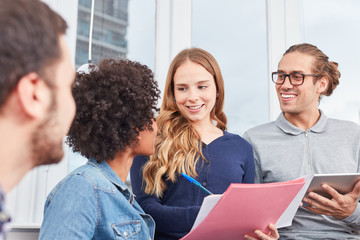 Young business woman with colleagues planning