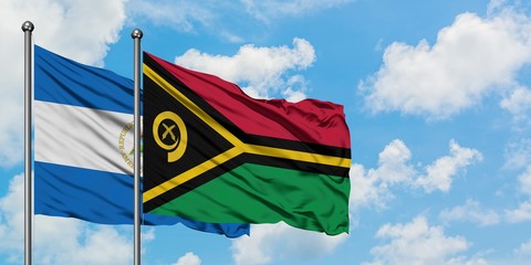 Nicaragua and Vanuatu flag waving in the wind against white cloudy blue sky together. Diplomacy concept, international relations.