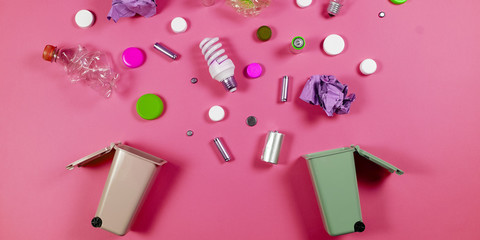 Trash bins and assorted garbage isolated on green, recycle concept,