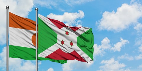 Niger and Burundi flag waving in the wind against white cloudy blue sky together. Diplomacy concept, international relations.