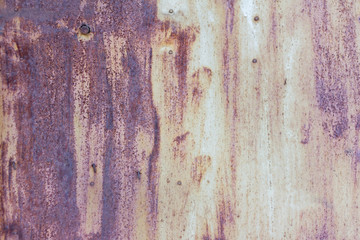 Grey corroded metal background. A rusty and scratched painted metal wall with nails and dents....