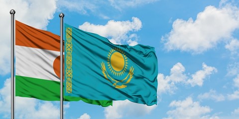 Niger and Kazakhstan flag waving in the wind against white cloudy blue sky together. Diplomacy concept, international relations.
