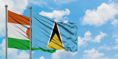 Niger and Saint Lucia flag waving in the wind against white cloudy blue sky together. Diplomacy concept, international relations.