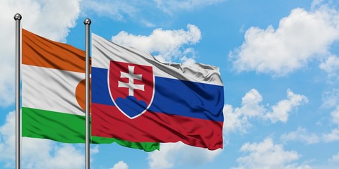 Niger and Slovakia flag waving in the wind against white cloudy blue sky together. Diplomacy concept, international relations.