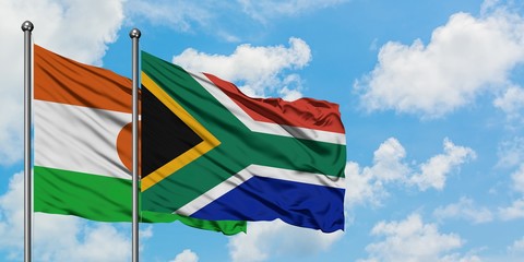 Niger and South Africa flag waving in the wind against white cloudy blue sky together. Diplomacy concept, international relations.