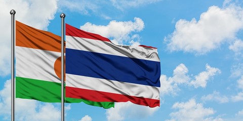Niger and Thailand flag waving in the wind against white cloudy blue sky together. Diplomacy concept, international relations.