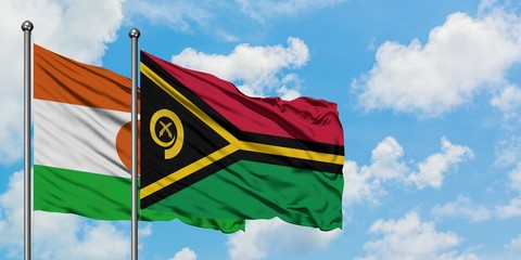 Niger and Vanuatu flag waving in the wind against white cloudy blue sky together. Diplomacy concept, international relations.