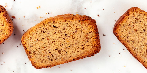 A close-up panorama of a chia seeds cake, shot from the top on a marble cutting board, healthy vegan baking