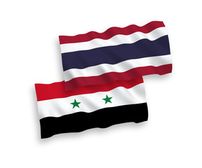 National vector fabric wave flags of Thailand and Syria isolated on white background. 1 to 2 proportion.