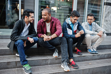 Fototapeta premium Group of four indian teen male students. Classmates spend time together.