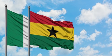 Nigeria and Ghana flag waving in the wind against white cloudy blue sky together. Diplomacy concept, international relations.