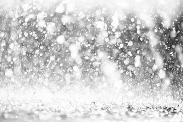 blue color tone of close up rain water drop falling to the floor in rainy season 