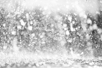 blue color tone of close up rain water drop falling to the floor in rainy season 