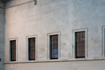 Fototapeta na wymiar windows in a white or light grey wall. windows of a buliding 