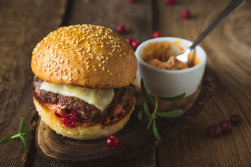 Big burger with cheese and cranberry sauce