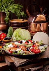 Vegetable and meat salad of mozzarella, cheese, olives, chicken, cucumber, tomatoes. Low carb dietary food.