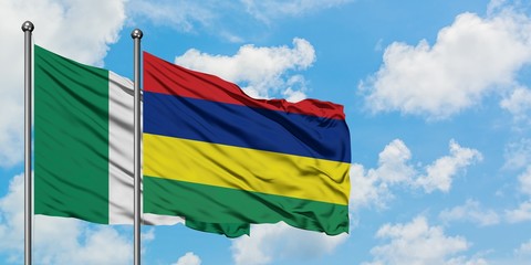Nigeria and Mauritius flag waving in the wind against white cloudy blue sky together. Diplomacy concept, international relations.