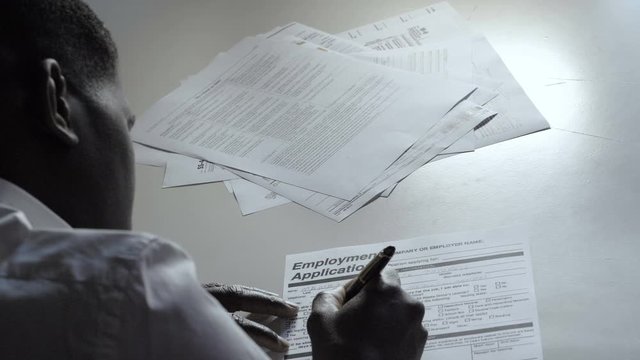 Black african man filling job application form. Work, immigration,youth