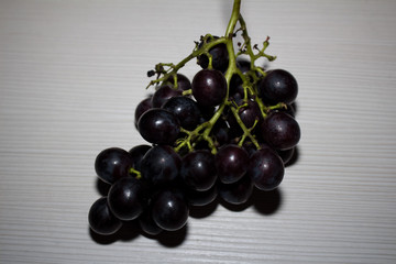 Blue grapes round shape on a light background