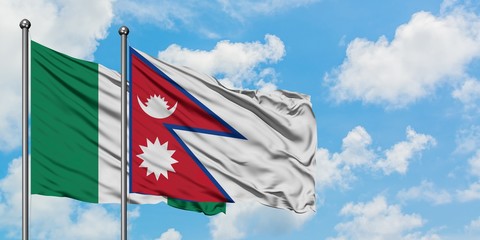 Nigeria and Nepal flag waving in the wind against white cloudy blue sky together. Diplomacy concept, international relations.