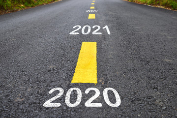 Number of 2020 to 2022 on asphalt road surface with marking lines, happy new year concept