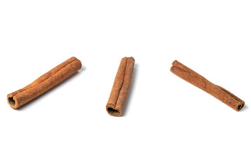 Three cinnamon sticks, isolated on white background. Closeup. Shallow DOF.