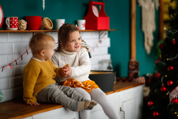 Cozy funny siblings together in kitchen,Christmas