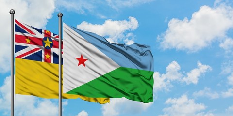 Niue and Djibouti flag waving in the wind against white cloudy blue sky together. Diplomacy concept, international relations.