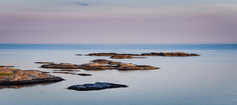 Rocky islands in the Norwegian sea at twilight with full spectrum vibrant color seascape