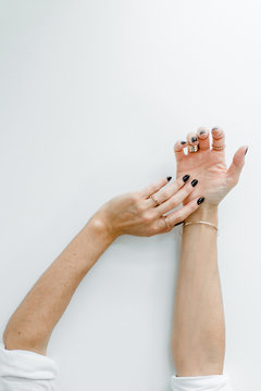 Hands with black manicured nails and accessoires