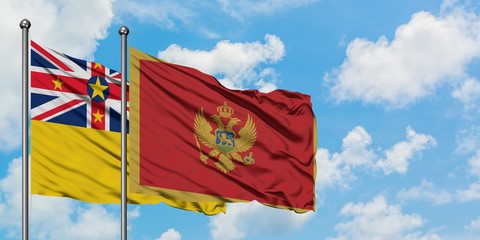 Niue and Montenegro flag waving in the wind against white cloudy blue sky together. Diplomacy...