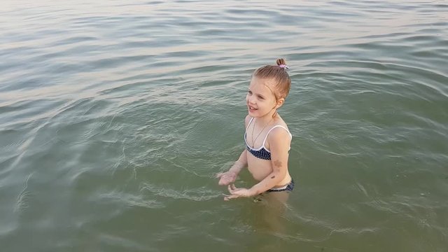 Little kid have fun to play on the beach.