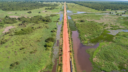 Aerial view of Transpantaneira dirt road crossing straight the typical landscape of North Pantanal...