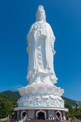 Danang Vietnam - October 24 th 2015: White Statue of Guan Yin (or Kuan Im) , the Goddess of Mercy in Taoism with sun rise in Danang Vietnam.