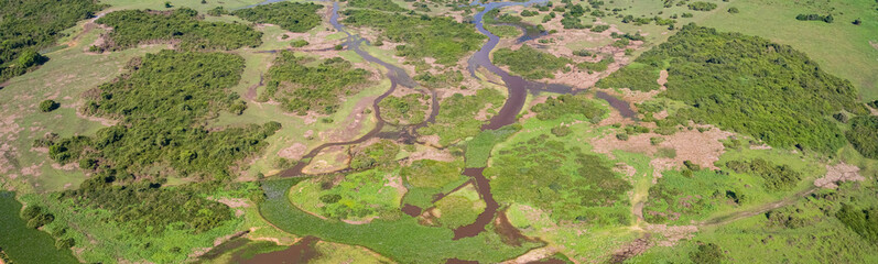 Aerial shot panorama of typical Pantanal Wetlands landscape with lagoons, forest, meadows, river,...