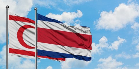 Northern Cyprus and Costa Rica flag waving in the wind against white cloudy blue sky together. Diplomacy concept, international relations.