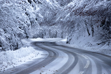 Empty road with snow banks on sides.