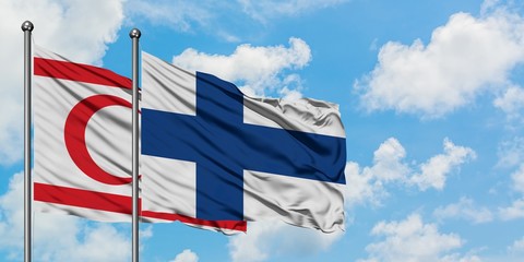 Northern Cyprus and Finland flag waving in the wind against white cloudy blue sky together. Diplomacy concept, international relations.