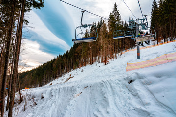 Fototapeta na wymiar Ski lifts of holiday complexes. In the Carpathians, winter landscape.