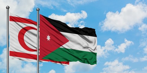 Northern Cyprus and Jordan flag waving in the wind against white cloudy blue sky together. Diplomacy concept, international relations.