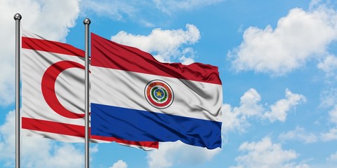 Northern Cyprus and Paraguay flag waving in the wind against white cloudy blue sky together. Diplomacy concept, international relations.